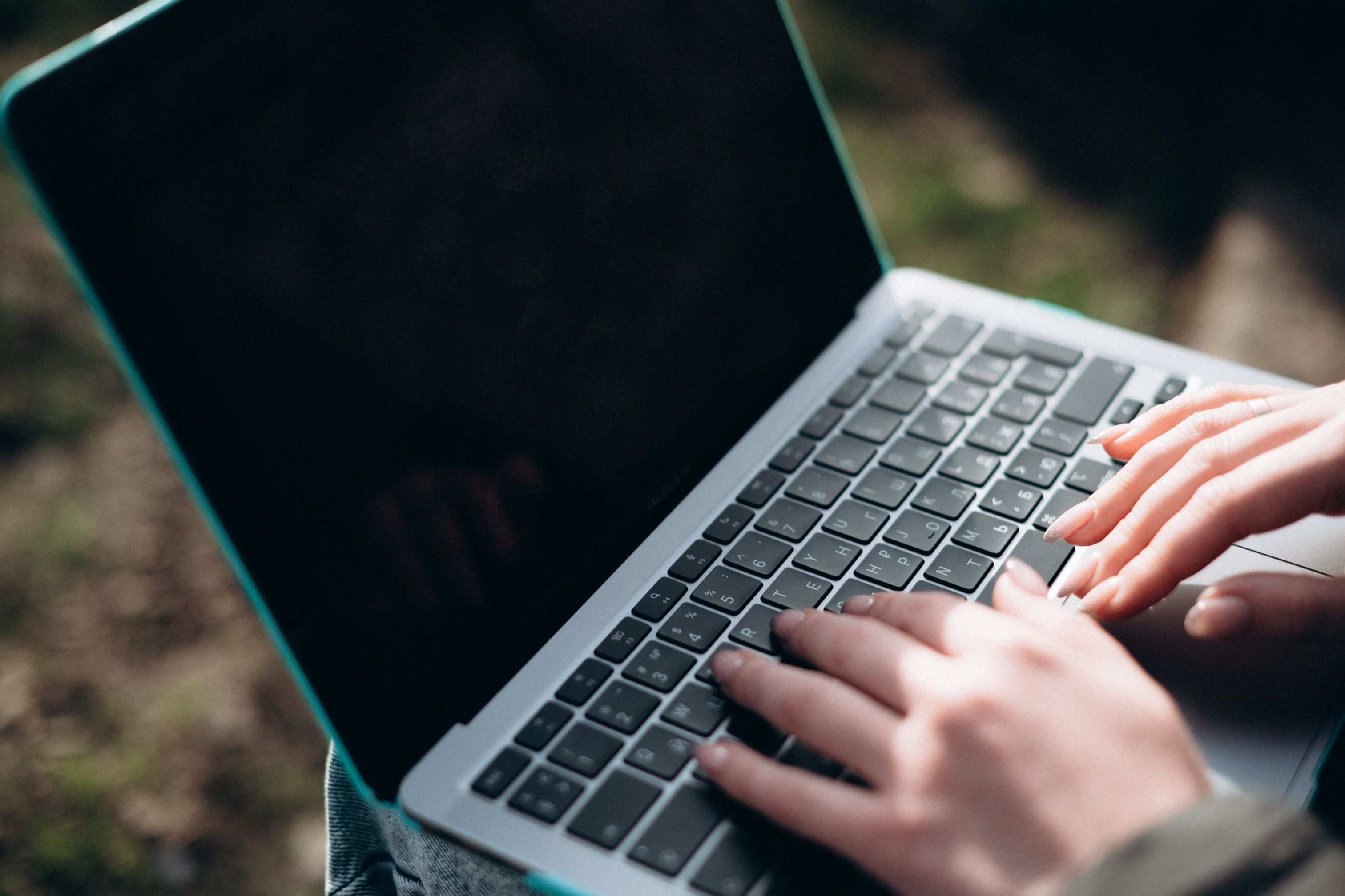 Hands typing integration code on a laptop keyboard